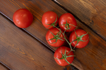 tomato on a brown wooden background, top view, text space, fresh vegetables