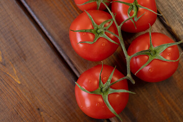 tomato on a brown wooden background, top view, text space, fresh vegetables