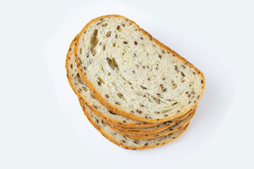 The cut loaf of bread with seeds isolated on grey background. Close up food photo.