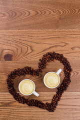 Cups of coffee in a heart shape form. Topview flay lay and copy space.