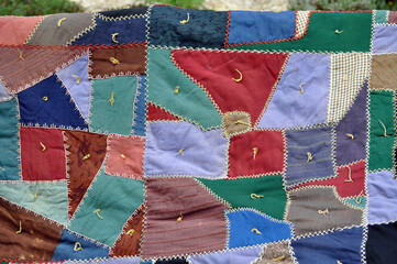 Close up of vintage crazy work wool quilt 