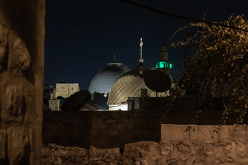 Evening view from Minzar HaMaronitim street on the roofs of Church of St. John the Baptist and Church of the Holy Sepulchre in the old city of Jerusalem, Israel