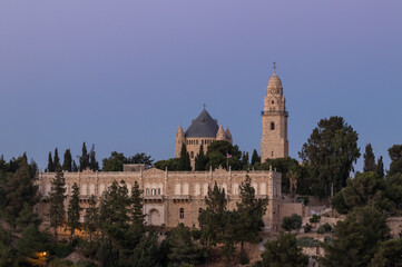 Fototapeta na wymiar View from the Jerusalem Mishkenot Sheananim - Hutzot Hayotzer quarter to the Dormition Abbey in the light of the rays of the setting sun in Jerusalem, Israel