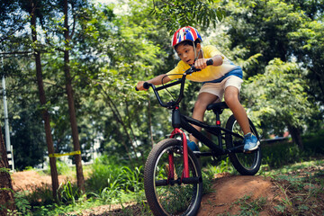 Fototapeta na wymiar Asian boy is training for a happy mountain biking.