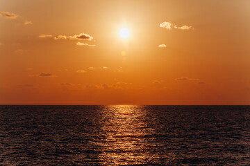 Beautiful sunset above the sea. Reflection of sunset in the water.