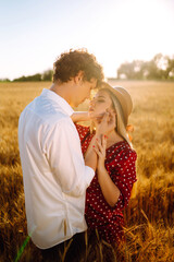 Portrait of  romantic couple at gold wheat field. The concept of youth, love and lifestyle.