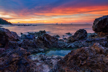 Colourful sunset view with a big rock as the foreground.Soft focus effect due to long exposure technique.