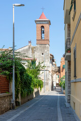 Vertical view of Via Pisacane in the historic center of Orbetello, Grosseto, Italy, on a sunny day