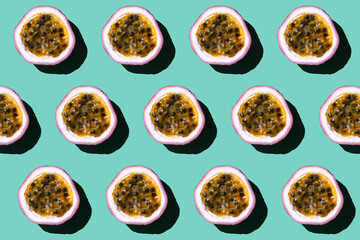 Colorful fruit pattern of fresh passion fruit on pastel green background.