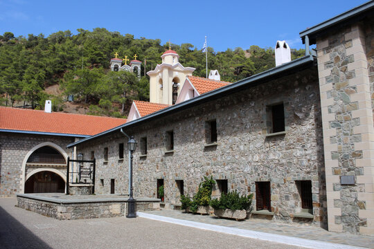 The courtyard of the Kikk monastery, where the Kikk icon of the mother of God is kept, against the background of a forest and a blue sky. Cyprus.
