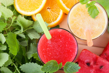 Summer cold drink smoothie orange watermelon. Bright, juicy, red yellow fruit cocktail with ice on the table, top view, concept diet and healthy food