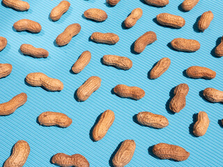 whole peanuts isolated on blue background