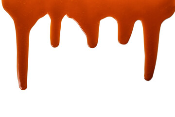Background of flowing caramel sauce isolated on white.