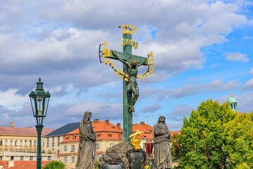 The statue Crucifix and Calvary on Charles Bridge in Prague, Czech Republic