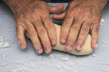 Hands doing the process of kneading raisin bread