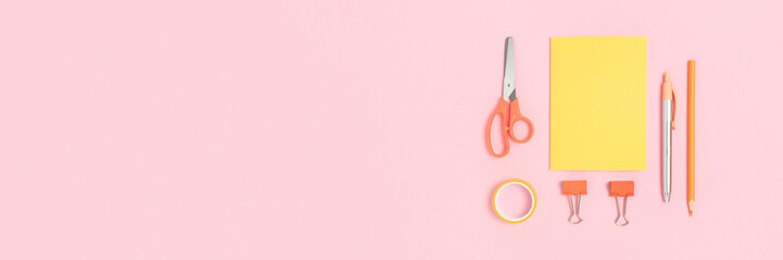 Set of yellow stationery on a pink pastel background. School banner design.