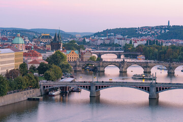 Fototapeta na wymiar View of three bridges over the River Vltava at sunset time in Prague, Czech Republic