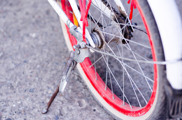 Bicycle footrest on a children's bike with red wheels.
