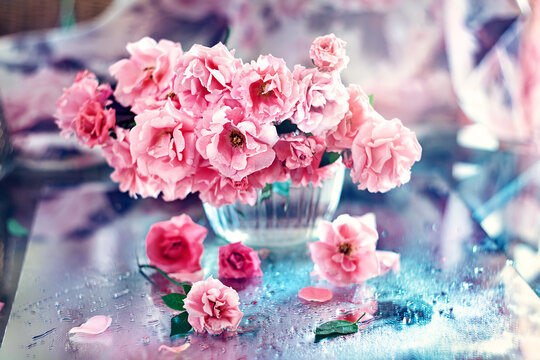 Floral composition with a roses on a table.Many beautiful fresh pink roses on a table.