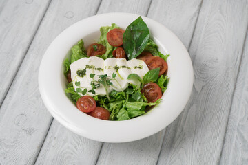 Green vegan salad from green leaves mix and vegetables.