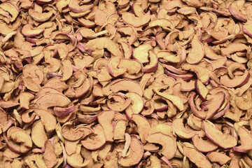 Background of chopped and dried red apples.