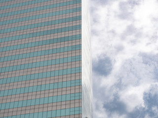 Fototapeta na wymiar Modern business center. tall building reflection with sky.