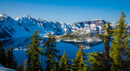 Snow covered rim of Crater Lake and Wizzard Island in Crater Lake National Park, Oregon.