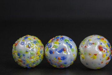 group of opaque white glass marbles with colorful sprinkles