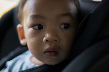 1 Year Old Adorable Asian Boy Alone Looking Around From Car Seat in the Car