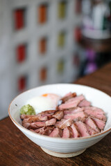 Steak Don, a Japanese dish consisting of a bowl of rice topped with rare beef with egg