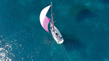 Aerial drone photo of beautiful sail boat cruising in low speed the Ionian turquoise calm sea