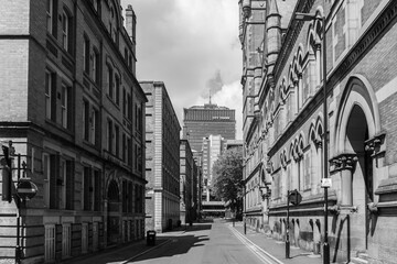 A black and white streetscape in Manchester showing the juxtaposition of differing architectural...
