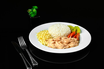 beef stroganoff served with white rice, potato straw and cooked vegetables