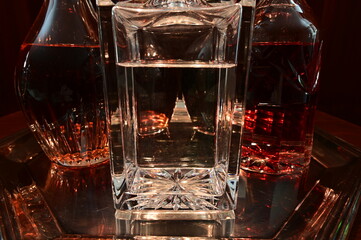 Closeup of decanters on silver tray containing variety of liquors with limited depth of field.