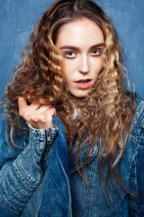Fototapeta premium young pretty blond curly girl posing happy smiling on blue background, lifestyle people concept
