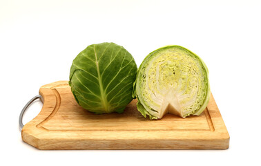 Sliced head of cabbage on a cutting board on a light background. Natural product. Natural color....
