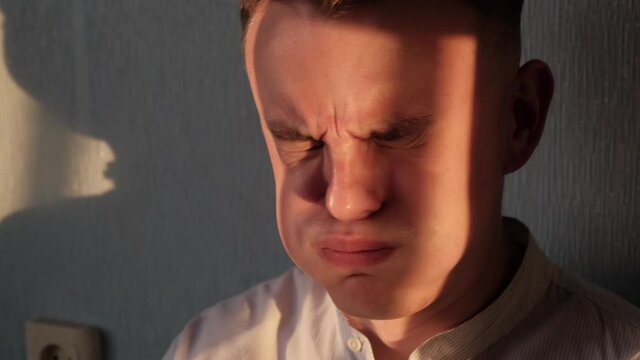 Young man feels the stink, closeup