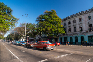 Havana, Cuba in February 2018. Traditional and colorful old cars with old buildings in the background.