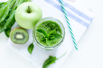 Green smoothie with spinach and apple. Summer and vegan foods and drinks concept.