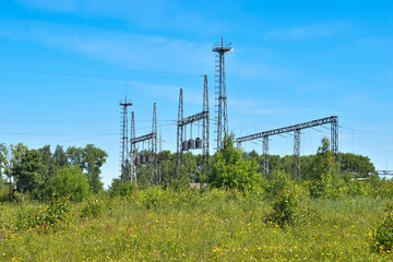 High-voltage power line outside the city in the field during the day