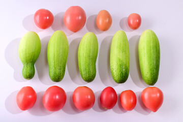 Cucumbers and tomatoes isolated from a white background