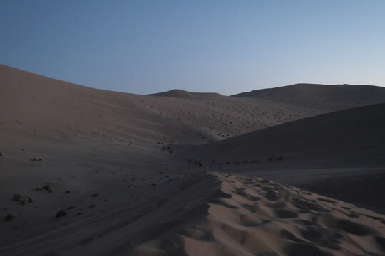 sand dunes and blue skyline at dusk. wide angle. At Dunhuang,Gansu province,China