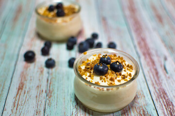 Lemon and blueberry yogurt and crunchy in a small glass