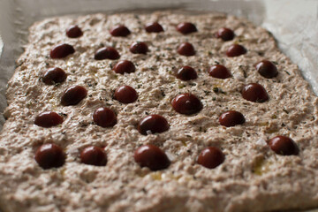homemade focaccia bread dough with cherry tomatoes