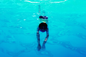 Athlete swimmer swims underwater, top view. Healthy lifestyle and sport concept.