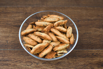 homemade bread sticks in a bowl with a wooden background