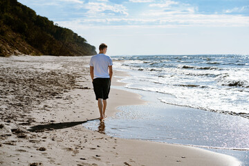 Man alone walking on the beach