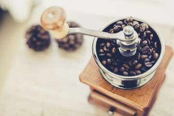 Roasted coffee beans in vintage style grinder