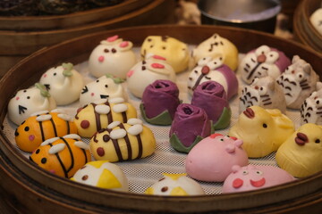 close up various funny Chinese steamed stuffed buns in bamboo steamer. Chinese buns with funny cartoon and animal shape