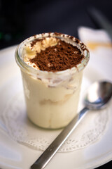 Typical Italian tiramisu dessert with sprinkled cocoa